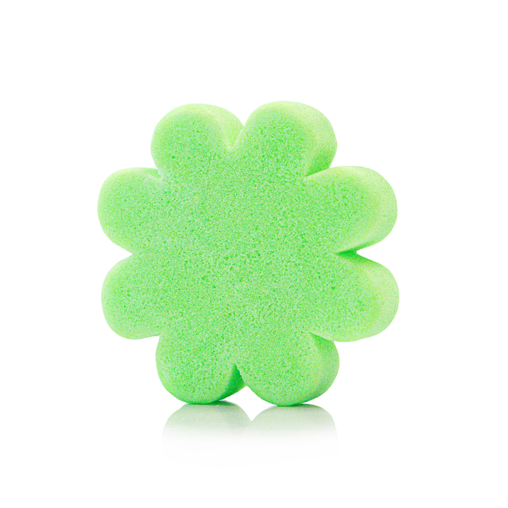 Green flower-shaped sponge on a white background